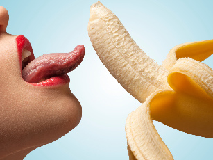 The girl licks the banana